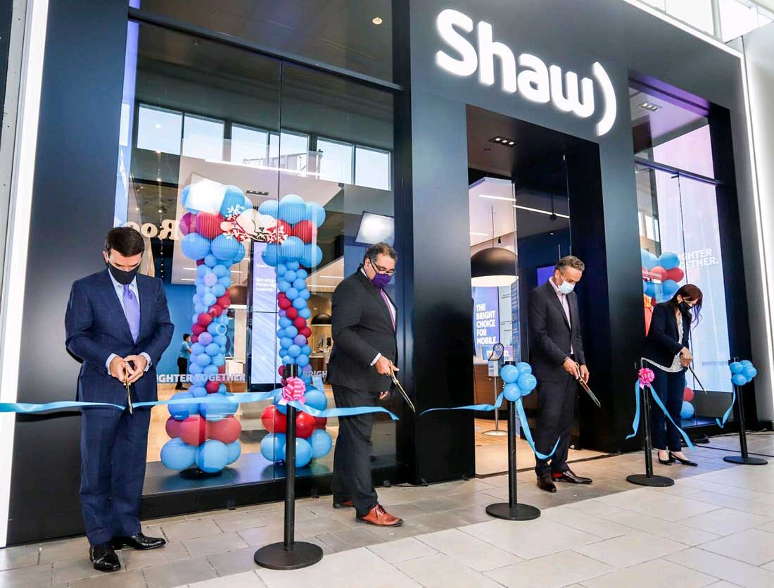 People cutting ribbon at a retail store opening