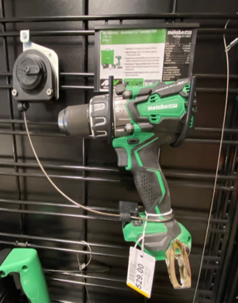 Power drill secured to a retail display with recoilers by RTF Global