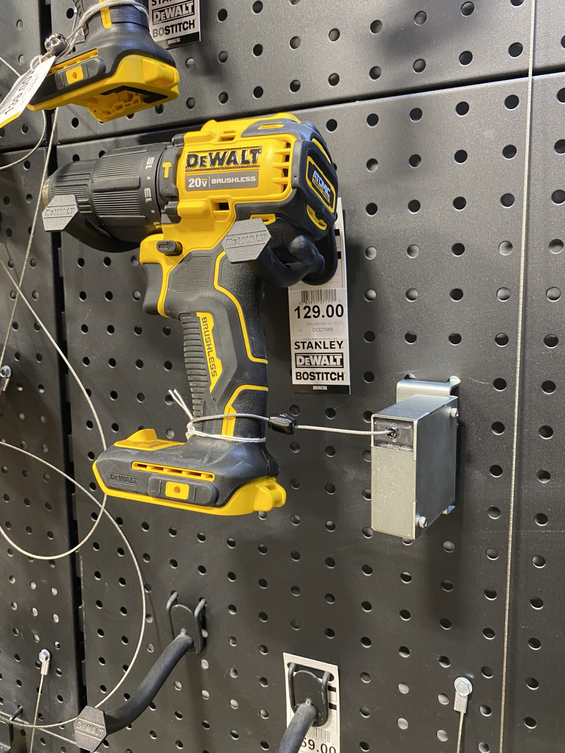 Impact driver secured to a retail display with recoilers from RTF Global
