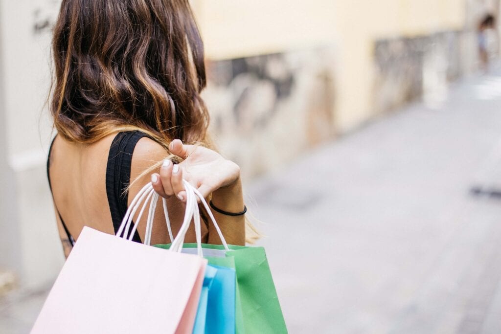 Shopper walking down the street with bags in hand